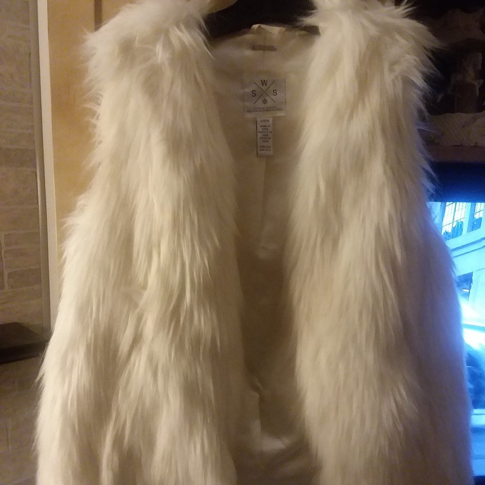 Soft fur creamy white faux fur vest. Pairs nice with a turtleneck.